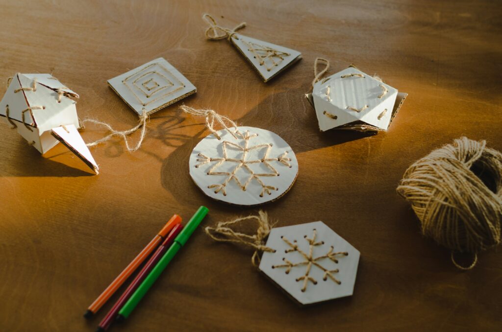 Handmade ornaments or gift tags, made from paper and thread