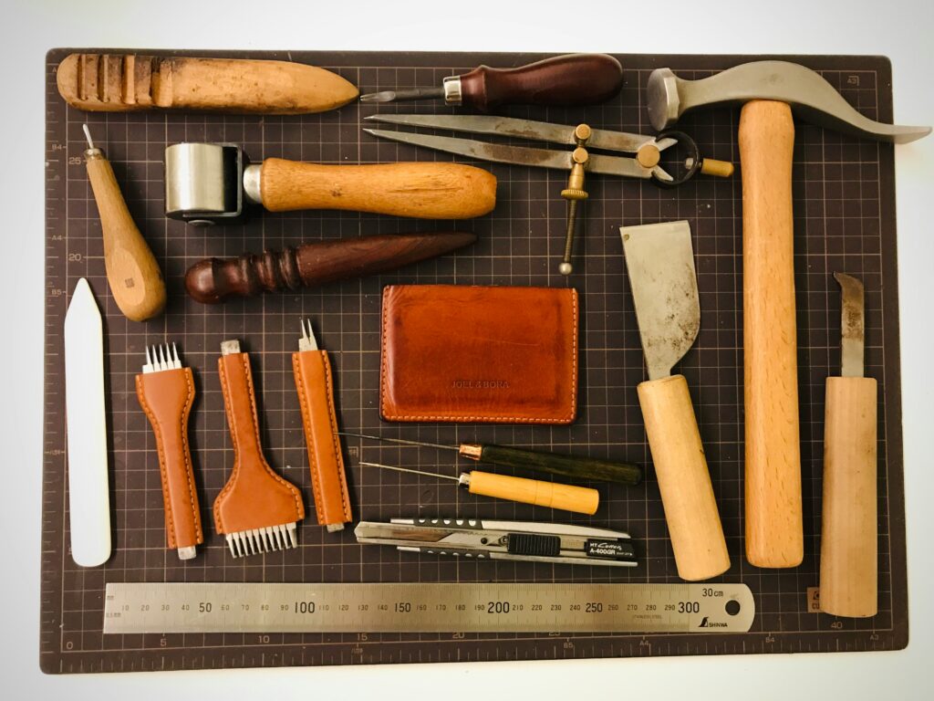 Leather tools laid out on a cutting mat