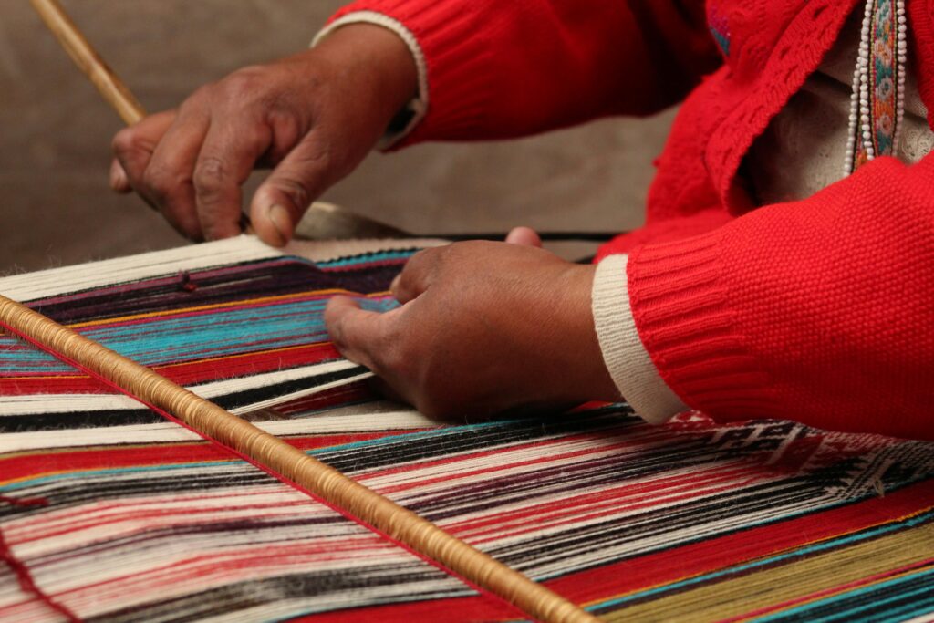 Handmaking a woven blanket on a loom